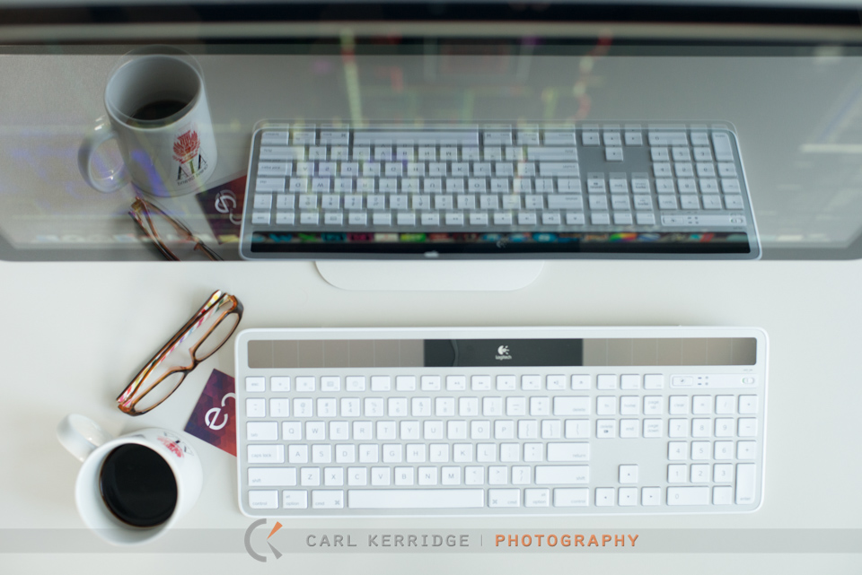 Lifestyle Photography of keyboard and coffee mug reflected in computer screen for e3 studios