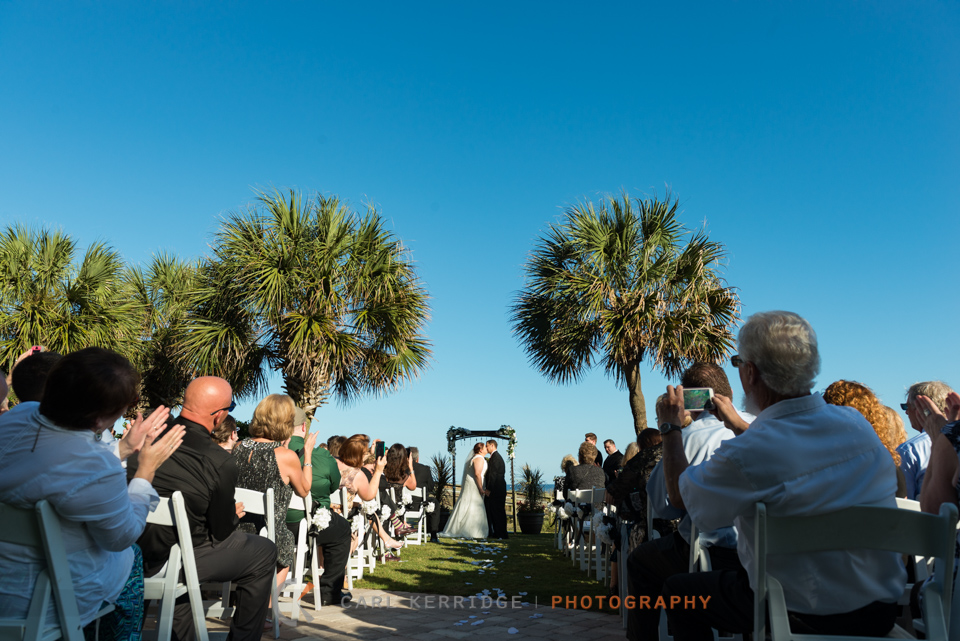 Beautiful blue sky and palm trees for this couples first kiss