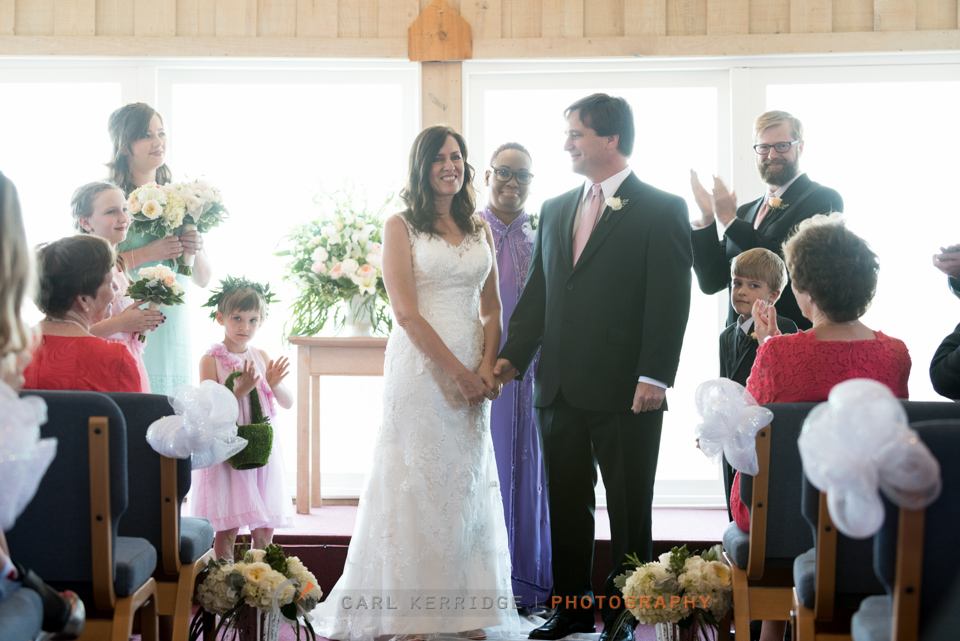 Guest clapping as the happy couple are announced at the alter in Pawleys Island Chapel