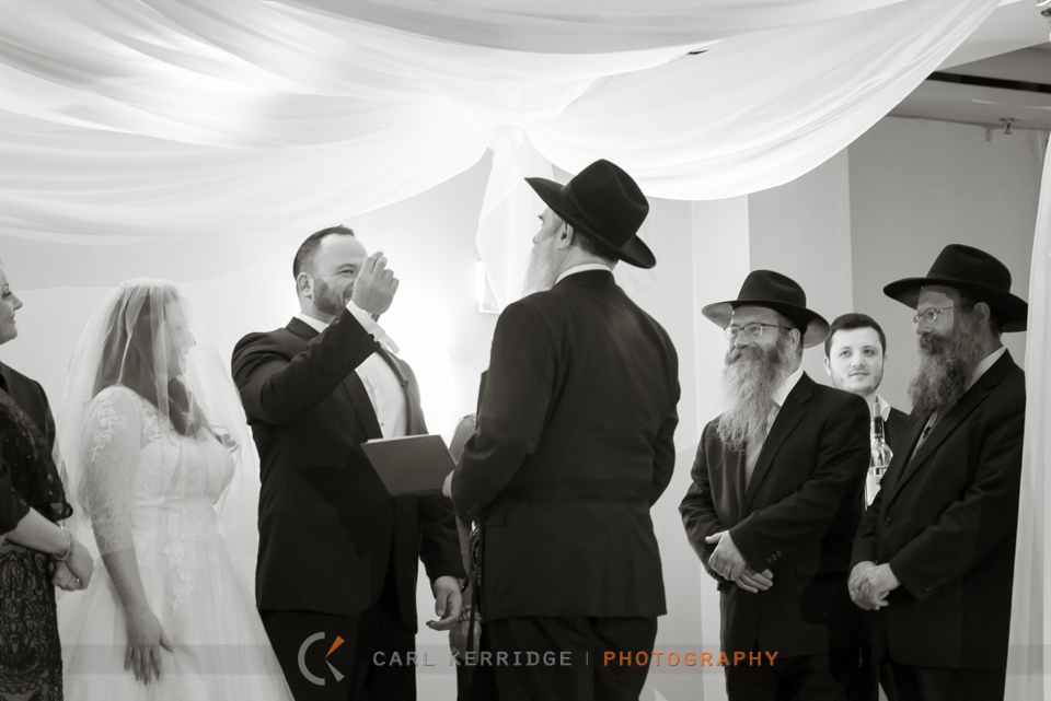 Myrtle Beach Wedding, Hilton Myrtle Beach conference room, Groom holds up wedding band for witnesses to inspect, Jewish wedding tradition under the chuppah