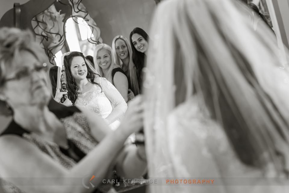 Myrtle Beach wedding, bride getting ready at salon, bride looking in the mirror, bride smiling at her friends