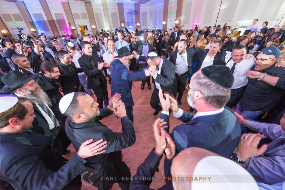 Myrtle Beach wedding, reception at Hilton Myrtle Beach, groom dancing with Rabbi in the center of the room, 500 guests surround and dance around the groom and rabbi, lots of smiling faces and mean clapping for the groom's Jewish wedding dance tradition