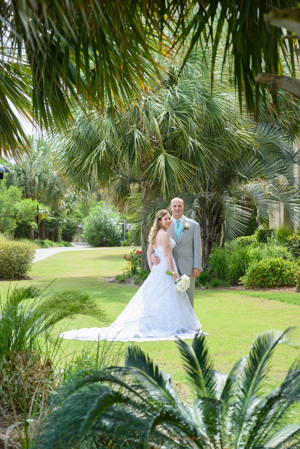 Wedding details, elegant bride and groom posed with palm trees in myrtle beach