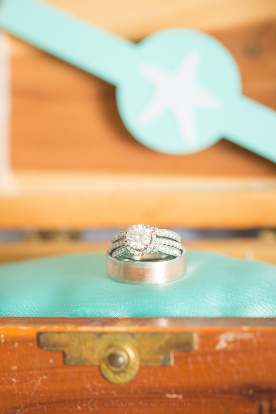 Wedding details, Beautiful wedding rings on teal cushion in wooden box