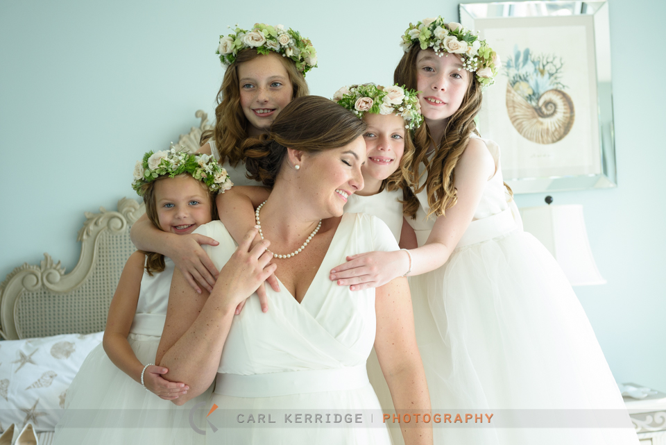the bride gives her flower girls a huge before the elegant wedding