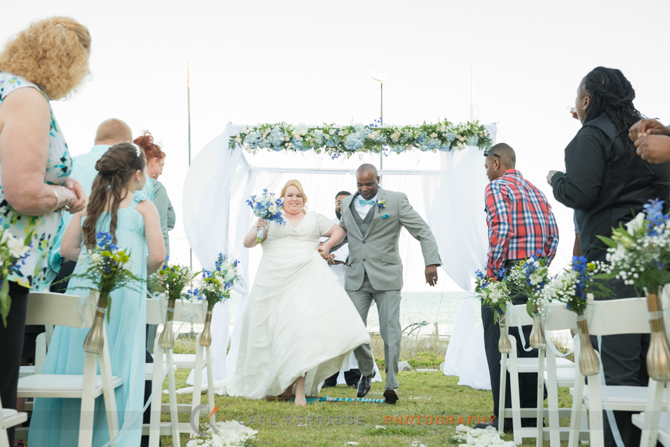 the bride and groom jump the broom before their Wedding Carriage Ride