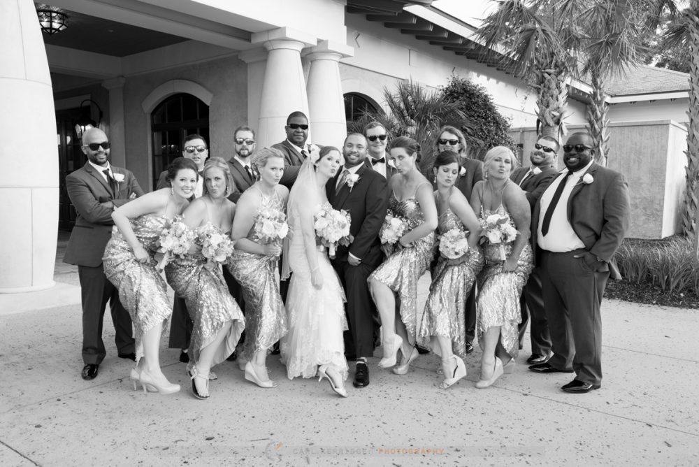 the wedding party pose for a fun photo for their photographer