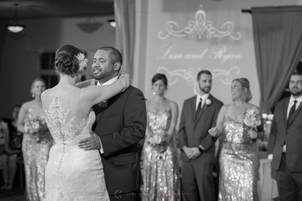 the bride and groom share their first dance at the wedding reception