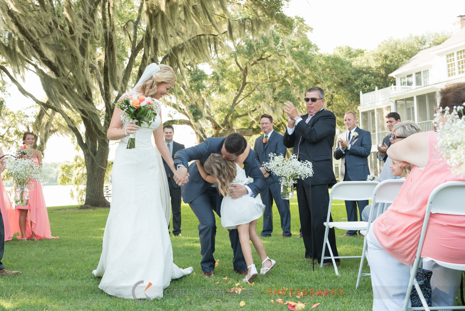 Groom hugging his daughter after wedding ceremony at Wachesaw Plantation