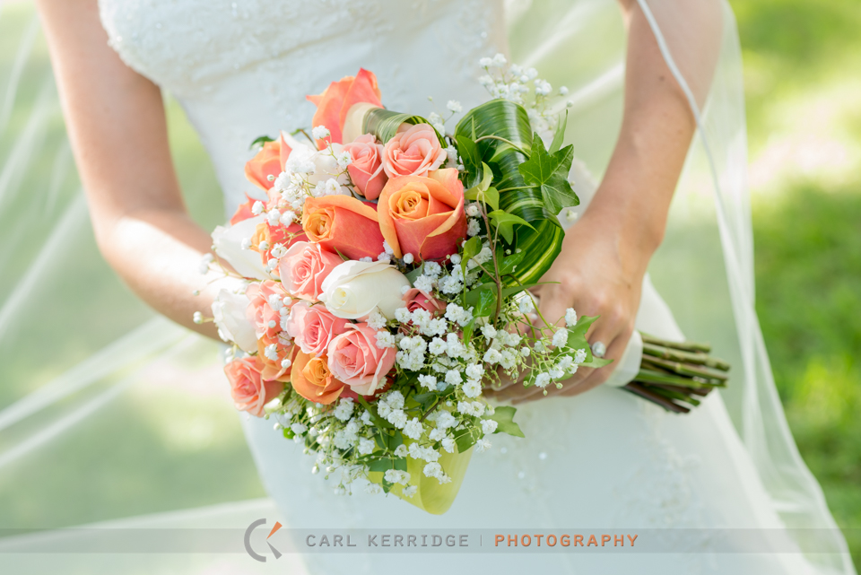 Gorgeous bridal bouquet of orange roses and babies breath