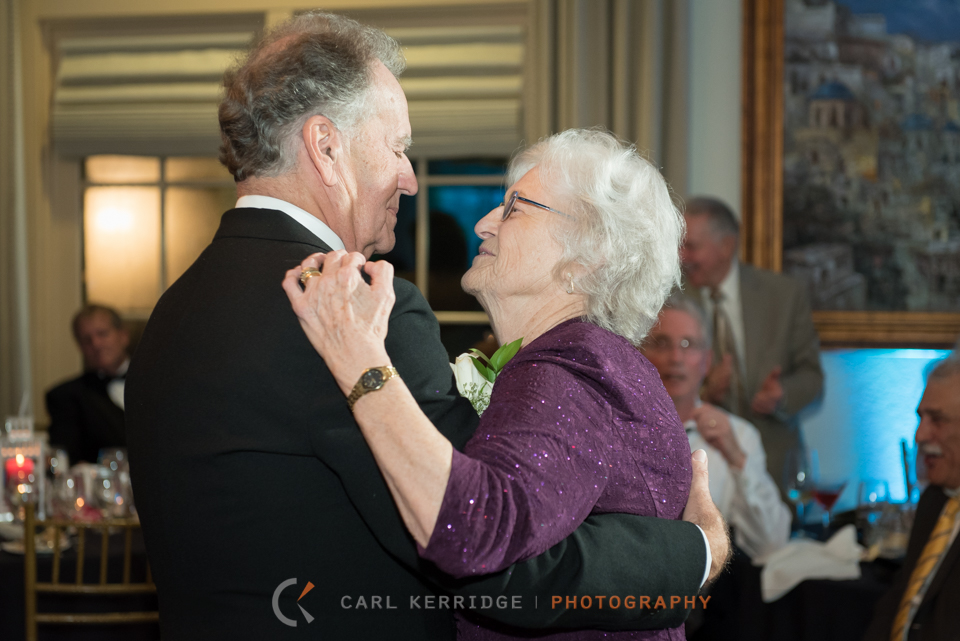 the brides parents dance at the couple's reception and look at each other admiringly