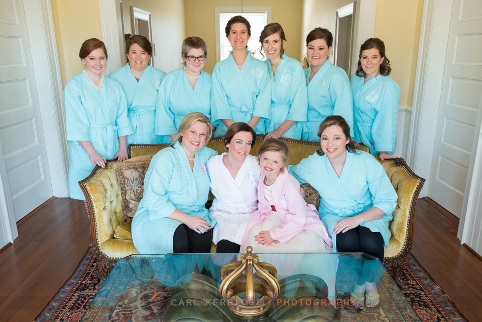 southern bride poses with her 9 bridesmaids in the upstairs parlor at Rosewood Manor in Marion, South Carolina