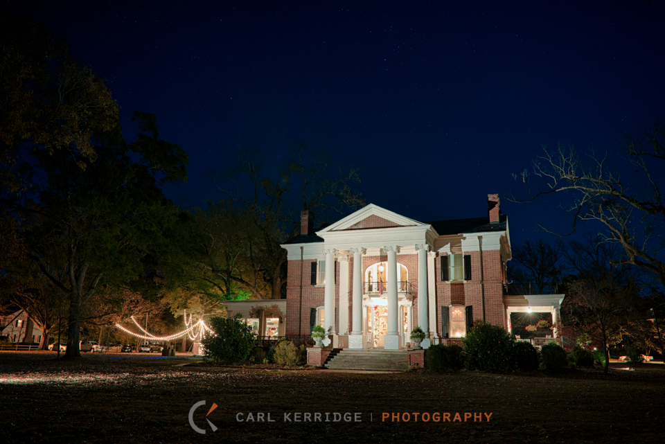 The Rosewood Manor is captured at night while stars twinkle and the wedding party dances under a canopy of lights.