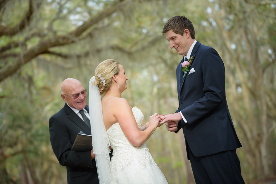 bride and groom exchange rings during their Litchfield Wedding