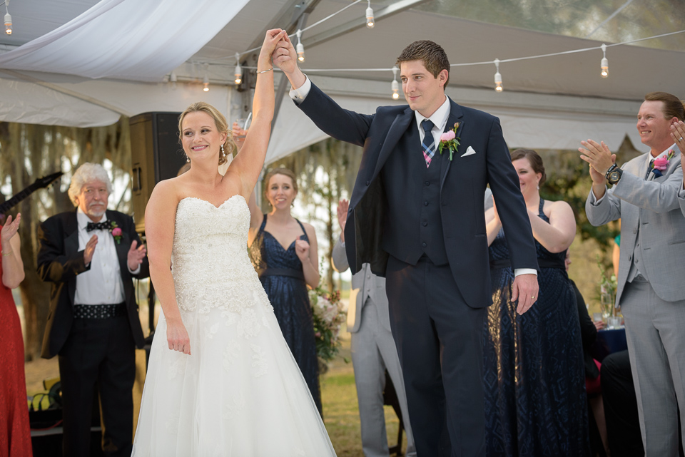 bride and groom raise their hands in the air during their Litchfield Wedding reception