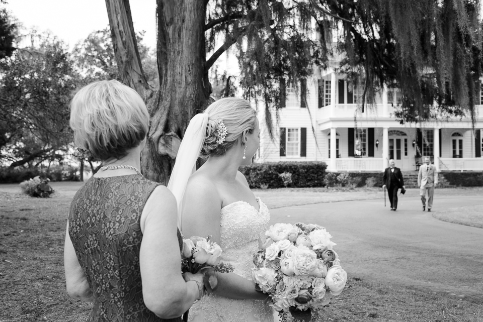 bride and her mom look back at brother and father during Litchfield Wedding portraits