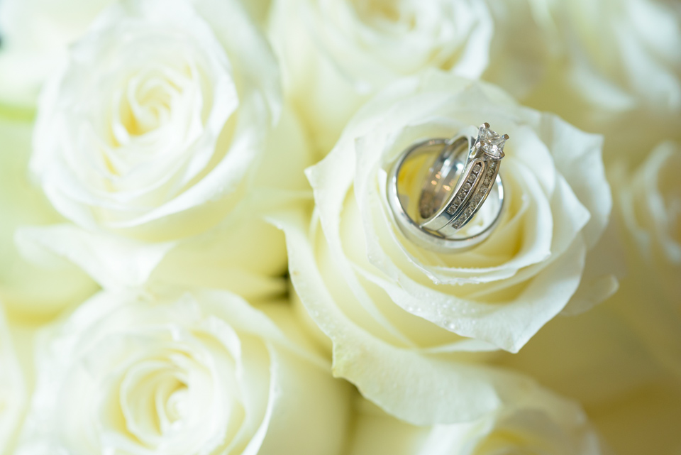 wedding rings sit on the rose bloom for myrtle beach wedding