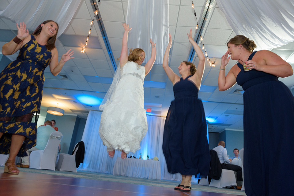 bride jumps in the air during the dance festivities at the reception