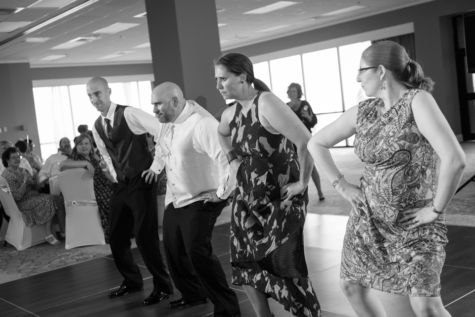 Groom and pals dance to make the bride laugh