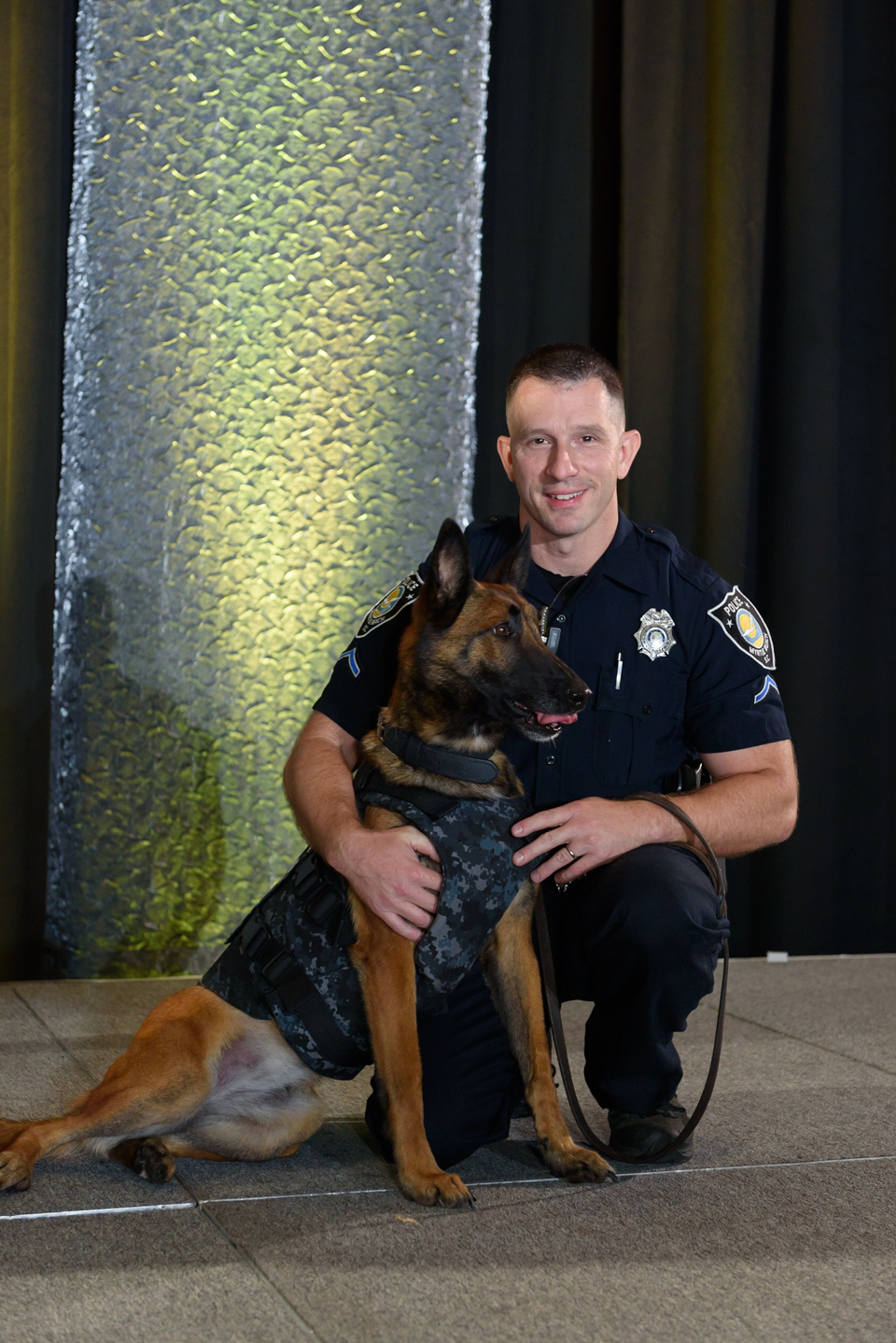 k-9 unit and his dog pose during awards at the blogpaws conference